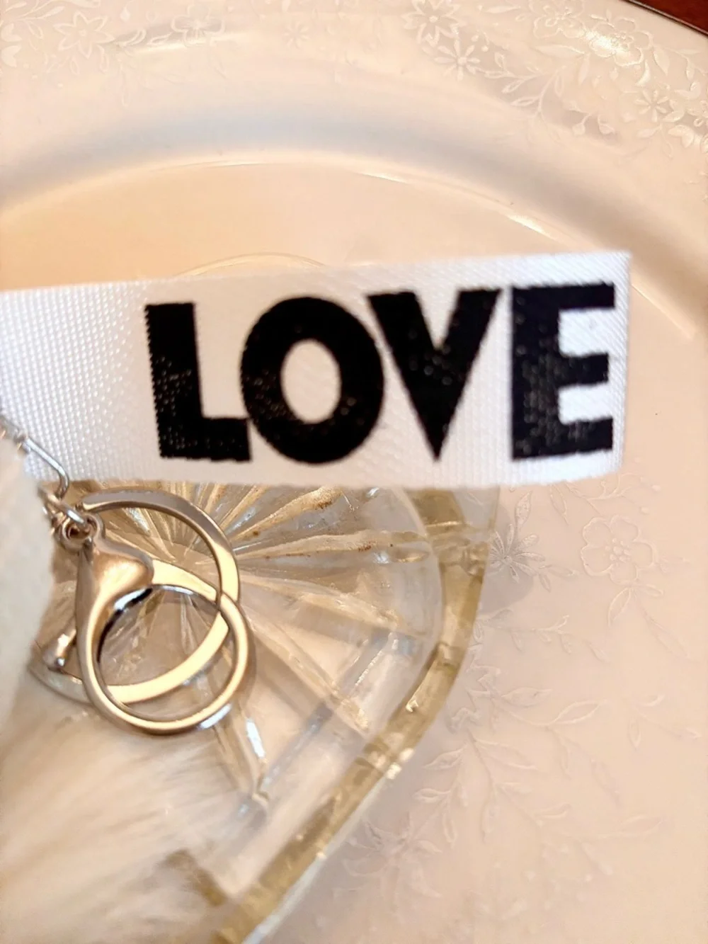 KEYCHAIN SLEEPING BABY DOLL  FLUFFY WHITE FUR POM POM AND A HAT THAT SAYS LOVE